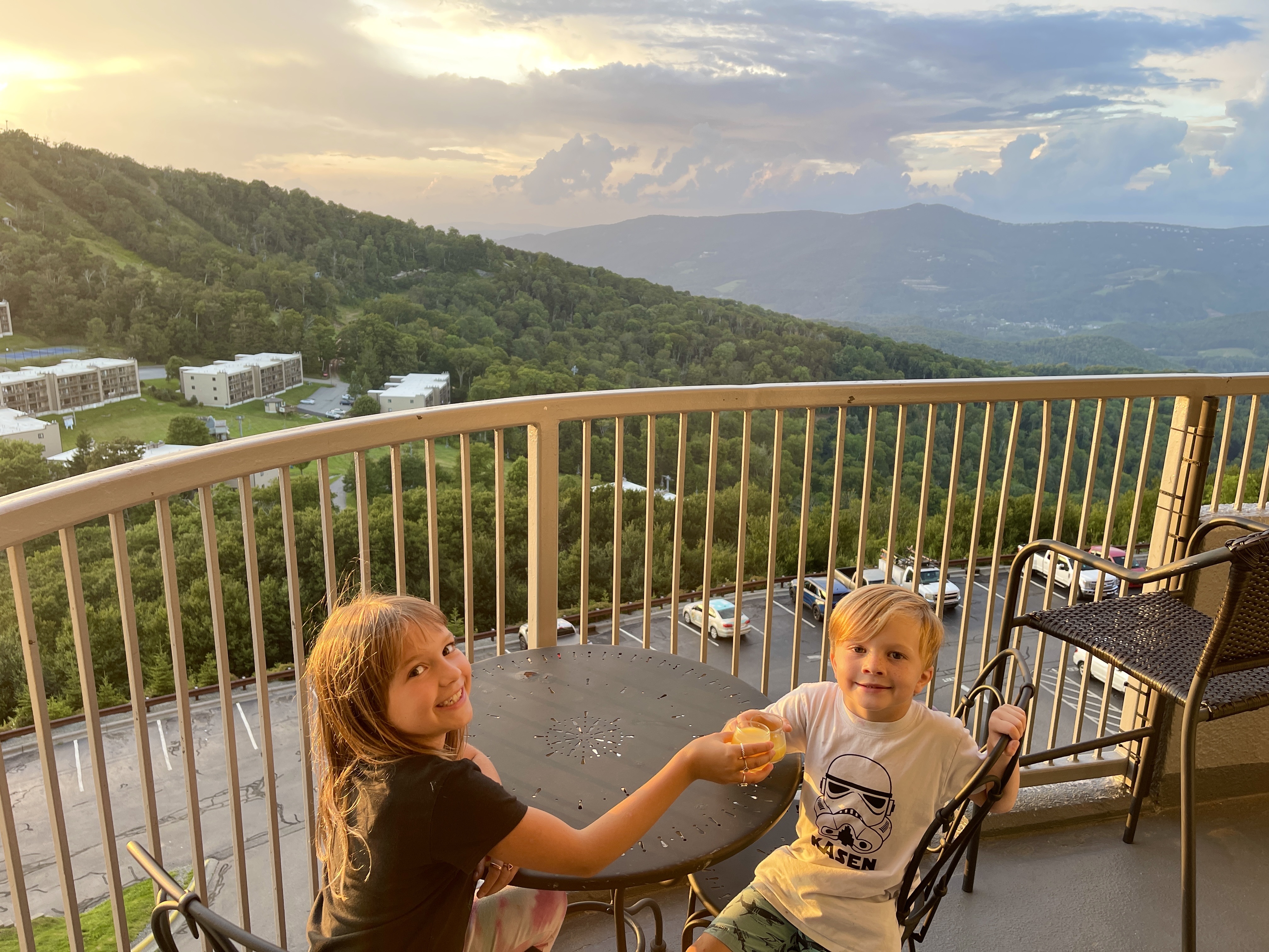 Kids at the balcony table at sunset