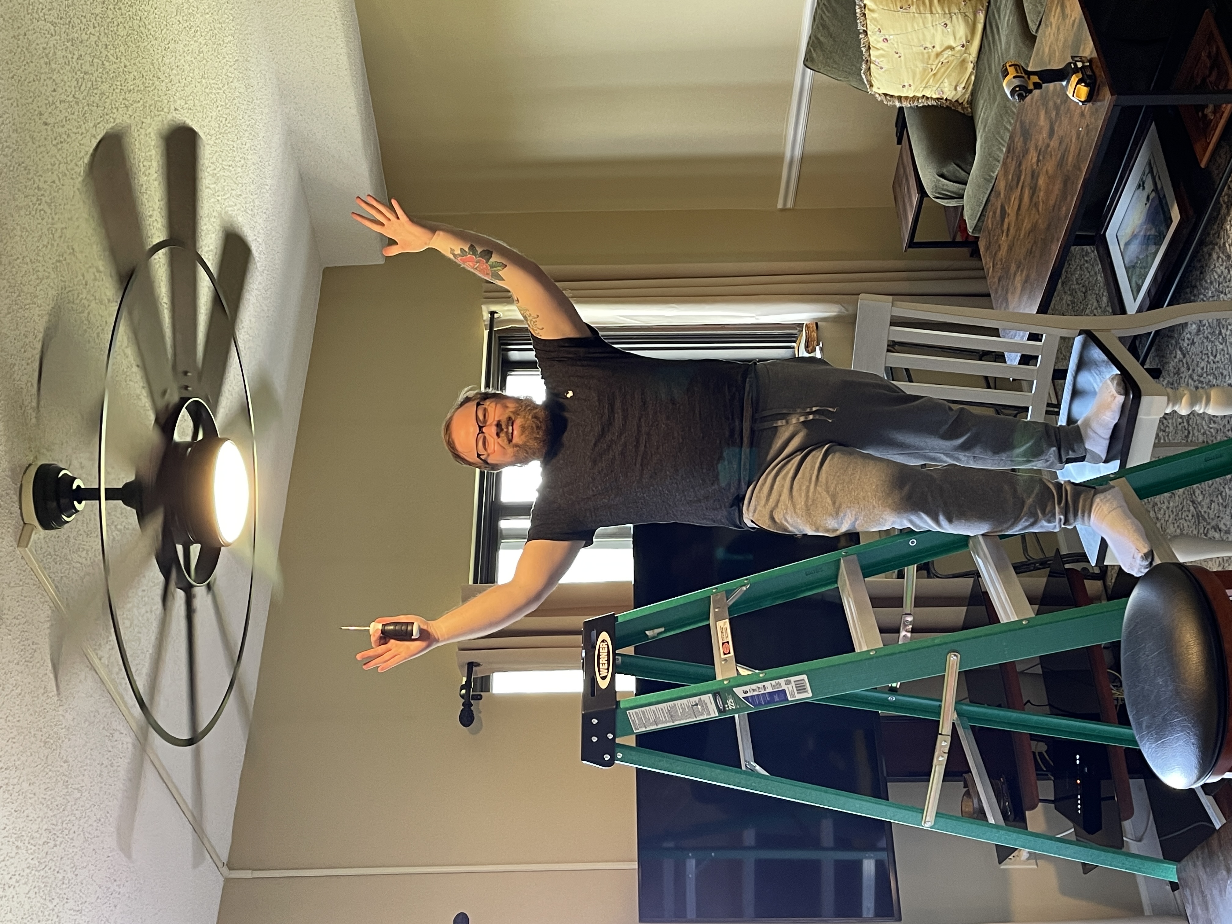 Nolan celebrating after installing the ceiling fan